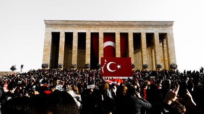 People gathered near the brown concrete building during the day
